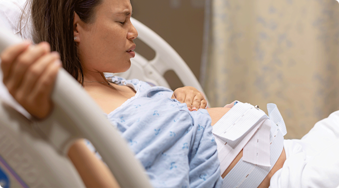 pregnant woman in labor in hospital bed