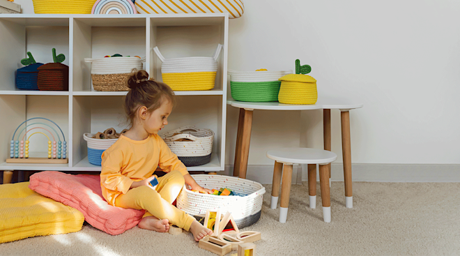 toddler putting toys away