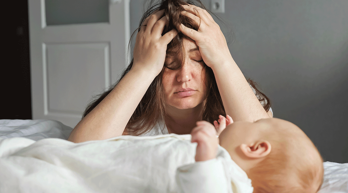 exhausted mother with baby