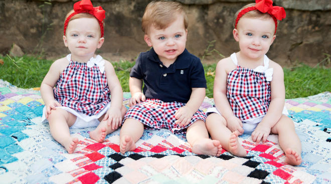 triplets outside wearing their 4th of july outfits