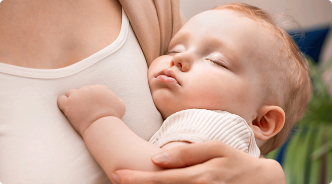 mom holding sleeping 9 month old baby