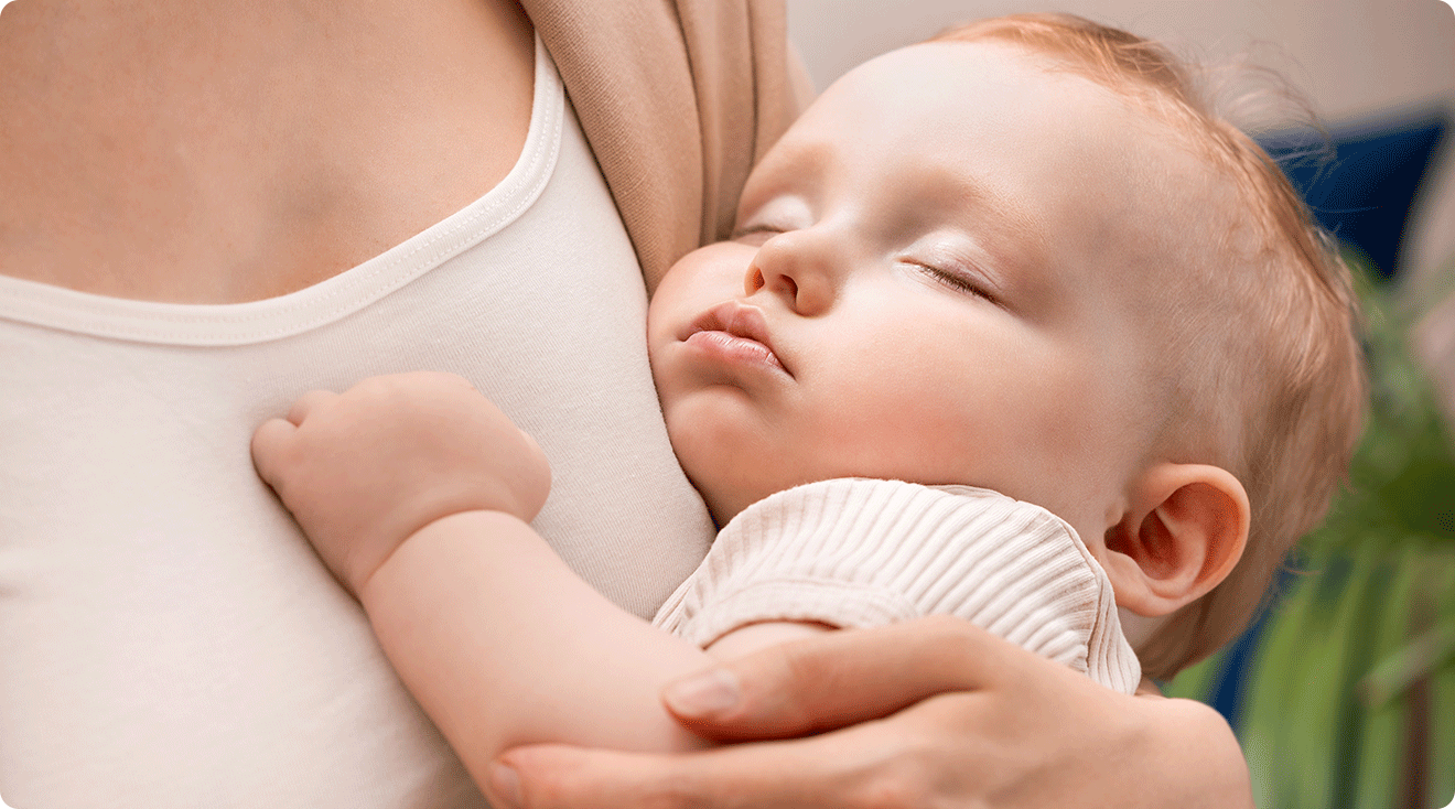 mom holding sleeping 9 month old baby