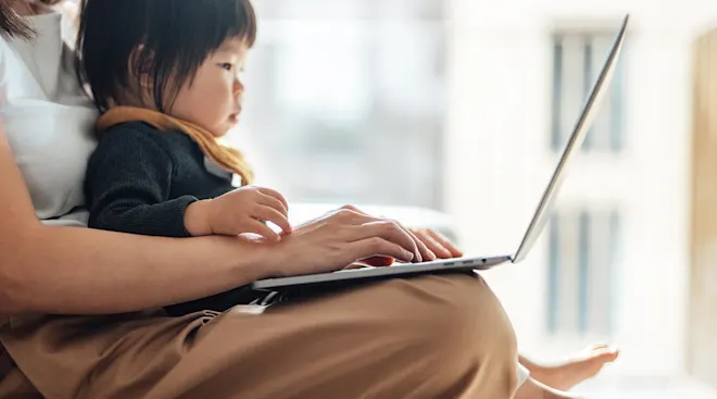 mother and baby using laptop to shop online