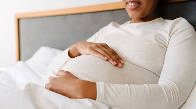 pregnant woman sitting in bed