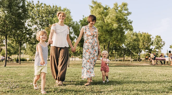 LGBTQ family walking in the park on a sunny day
