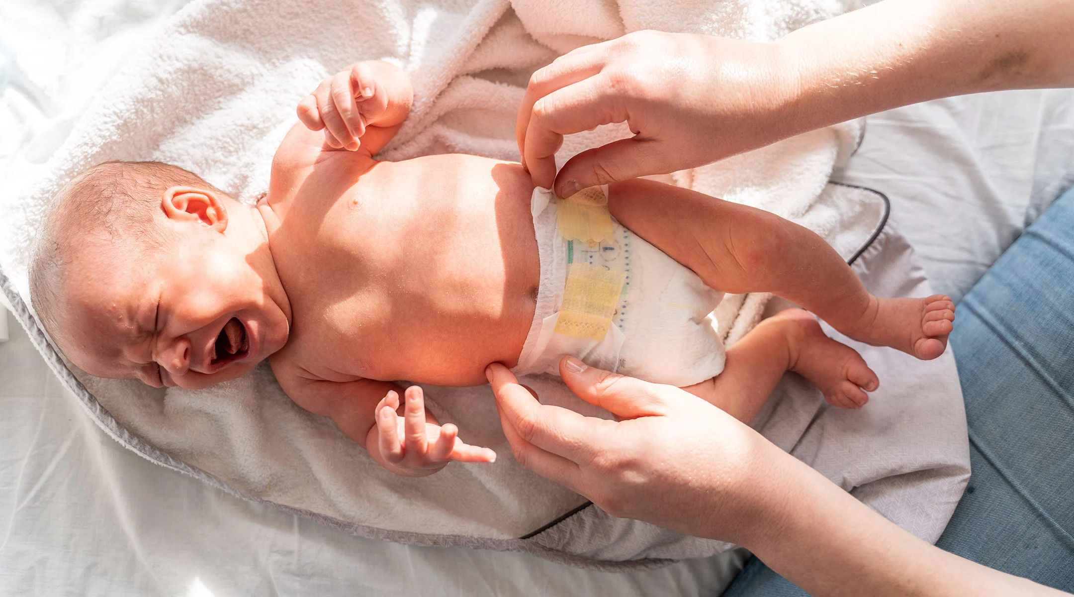 fussy new baby getting its diaper changed