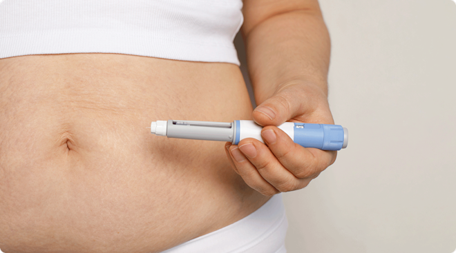 woman holding ozempic or GLP-1 injection 