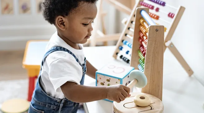 little boy playing with montessori toys