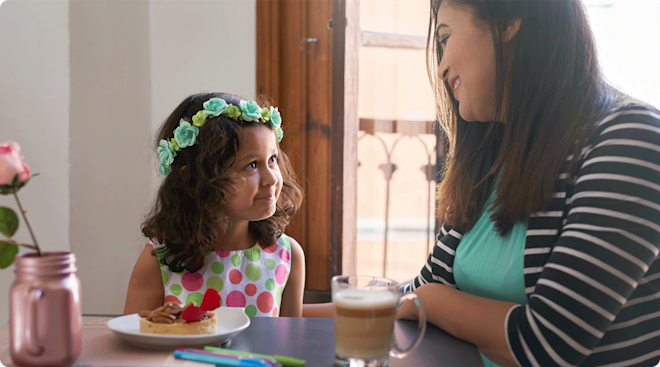 mom and young daughter talking at home