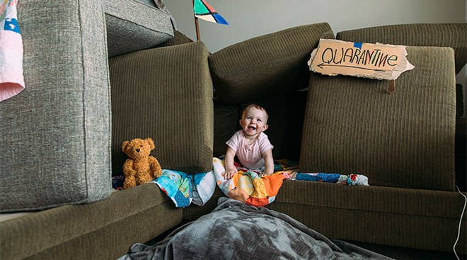 baby in couch fort during quarantine