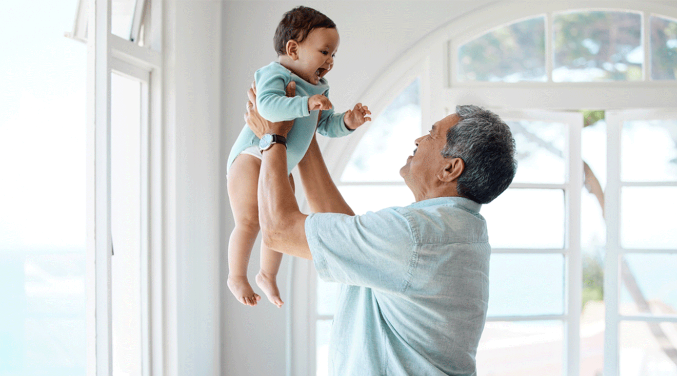 grandpa and smiling baby playing at home