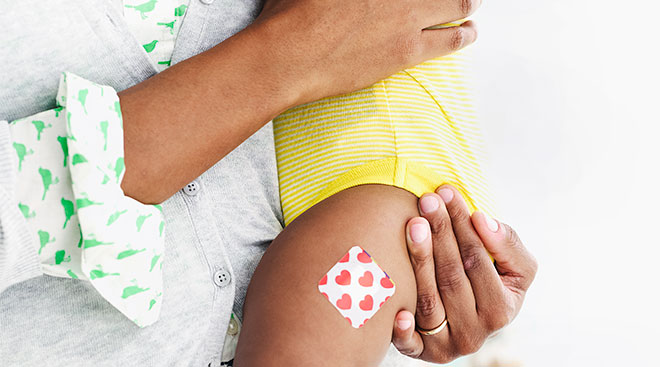 mom holding her baby after it had a vaccine