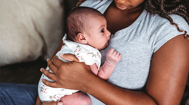 mom holding her newborn baby close to her chest