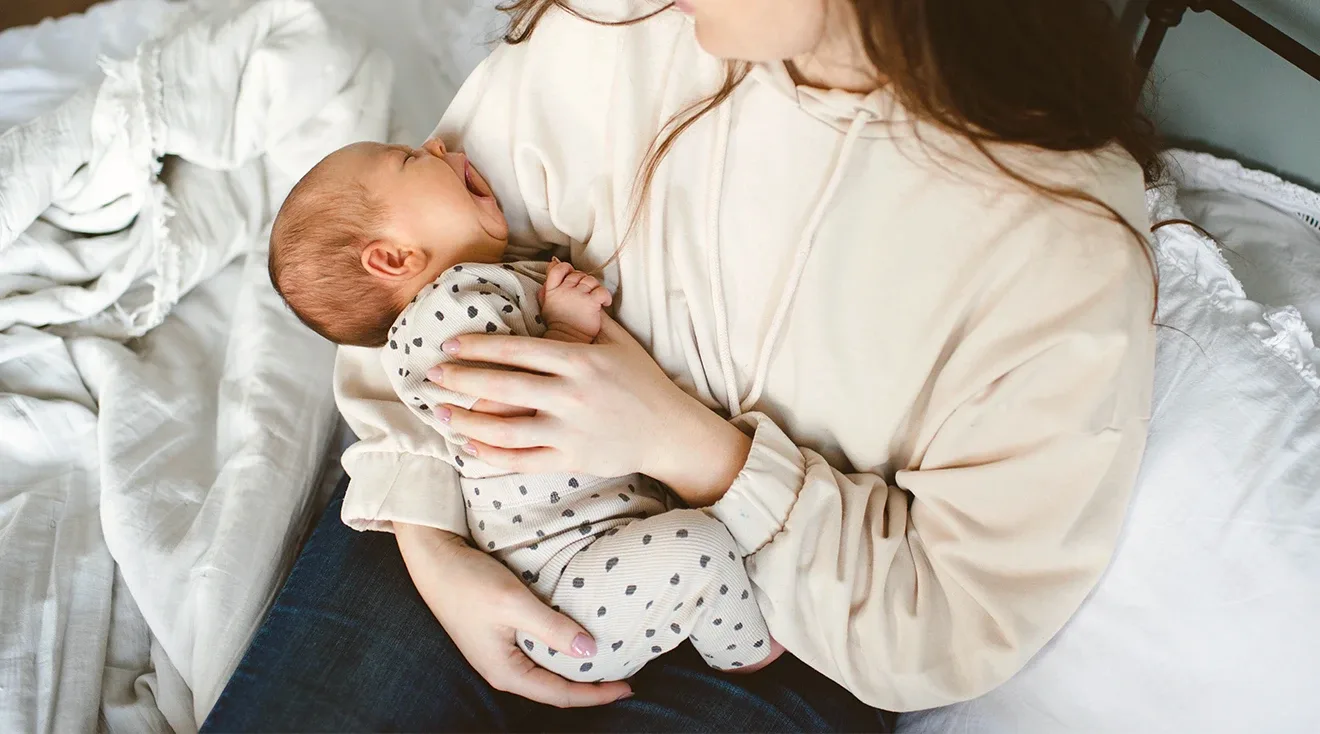 mother holding crying baby