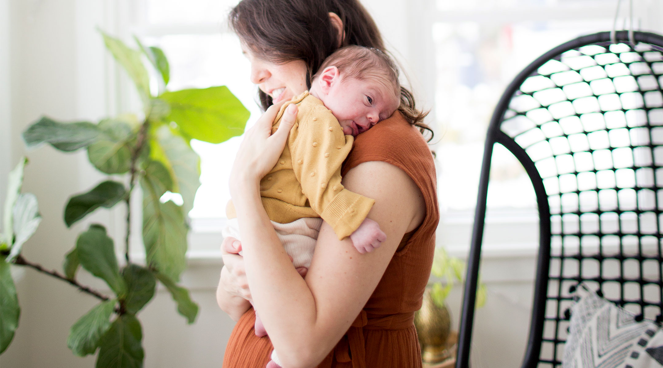 mom holding her newborn in the postpartum period