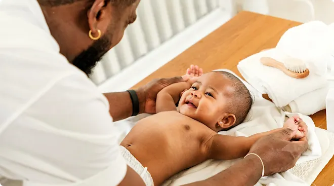 mother using changing table to change baby's diaper