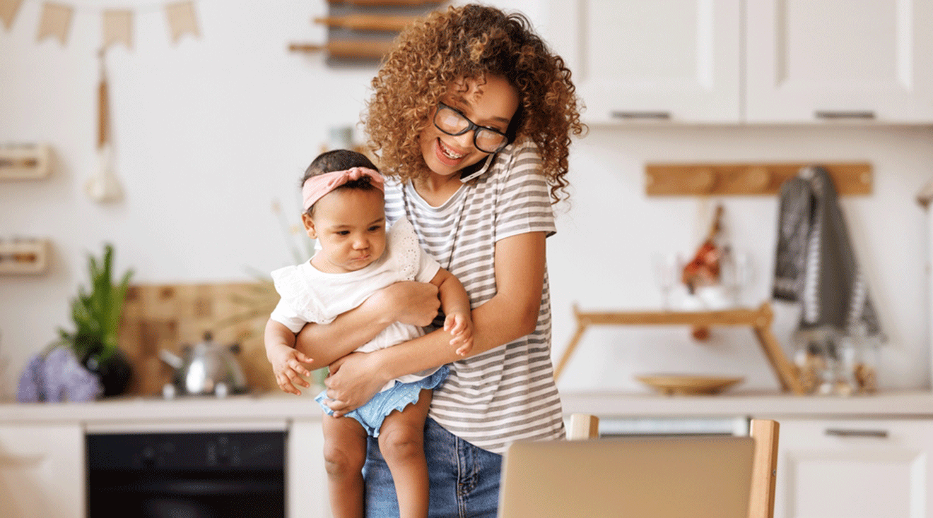 busy mom holding baby at home