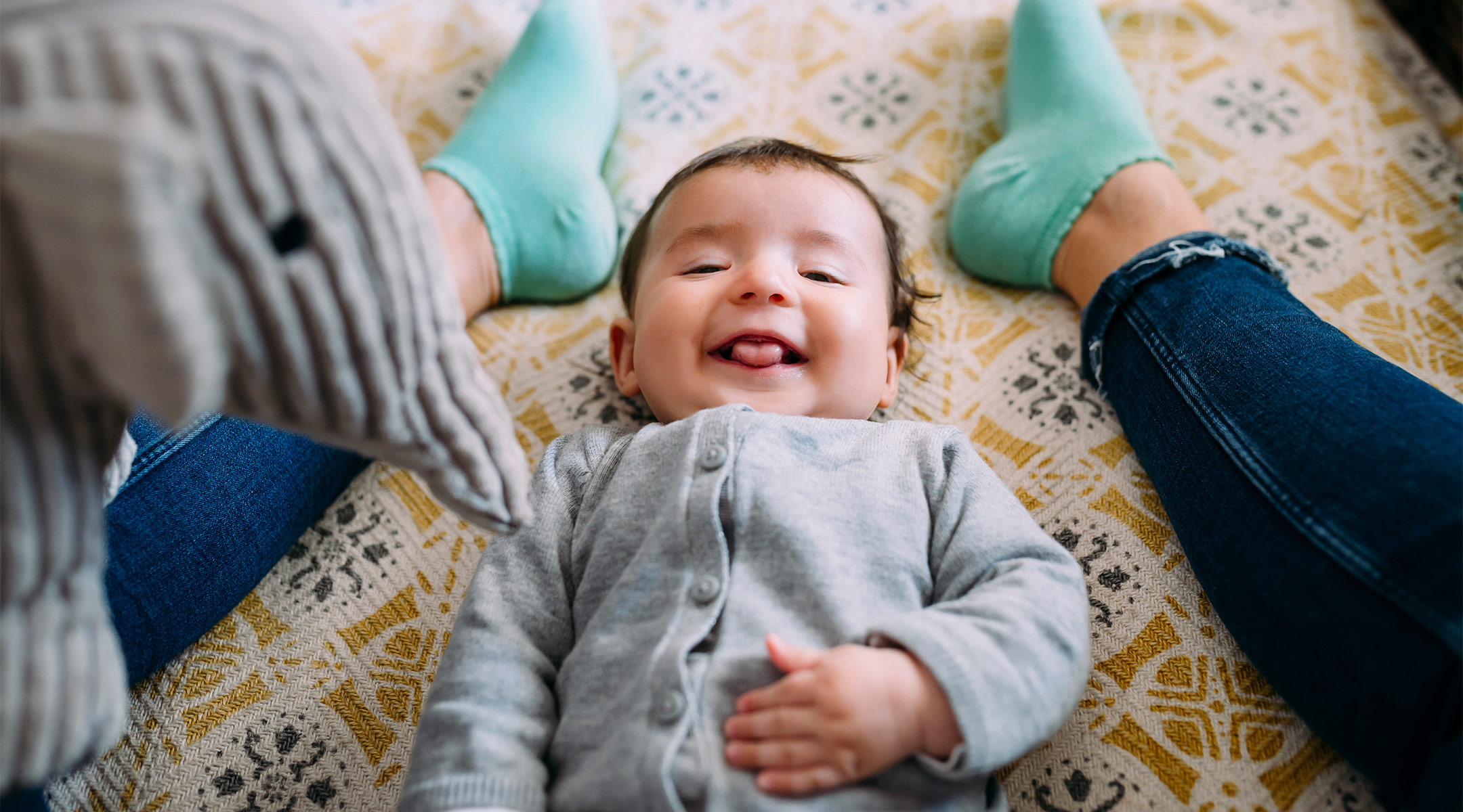 happy baby sitting in mom's lap