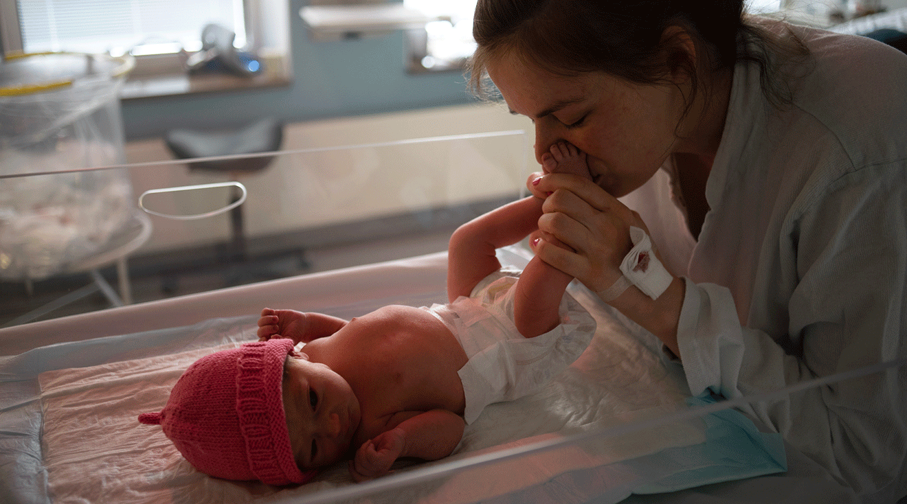 mother visiting newborn baby in the NICU