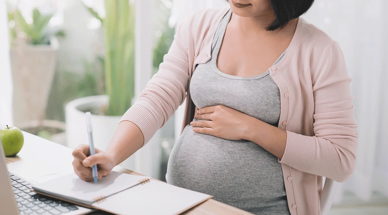 pregnant woman working at desk
