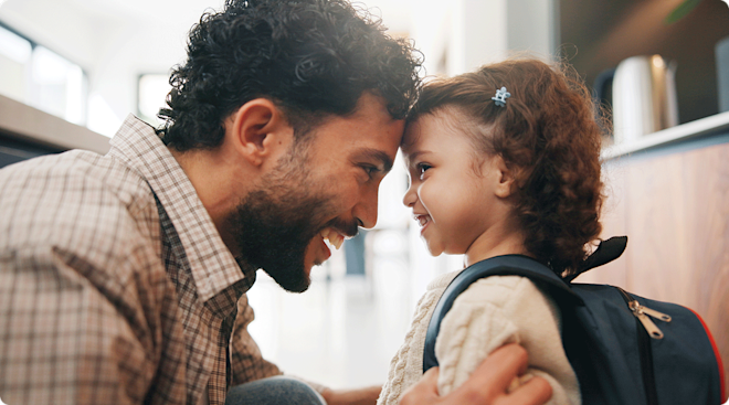 A dad preparing his daughter for preschool. 