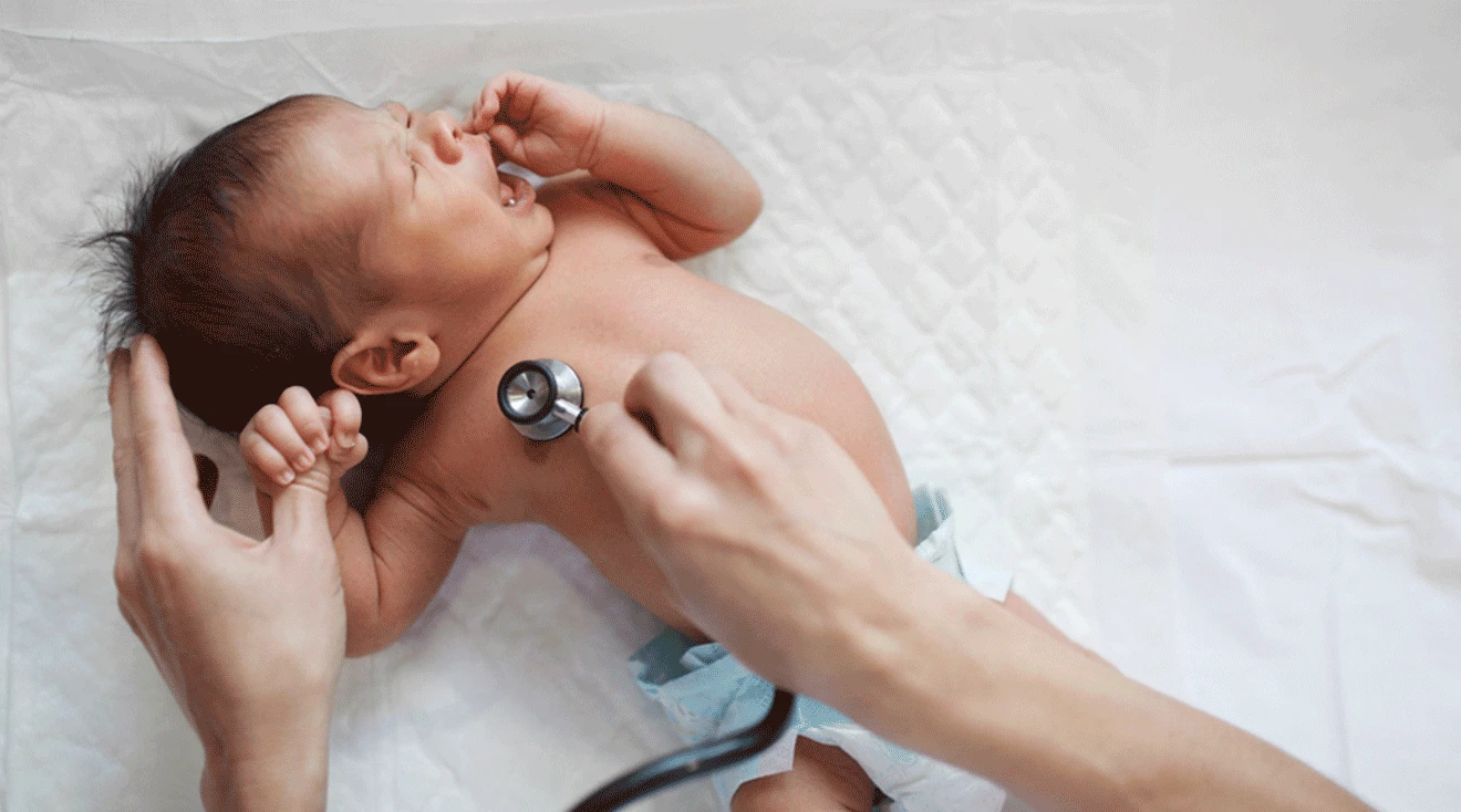 doctor listening to 1 month old baby's heart