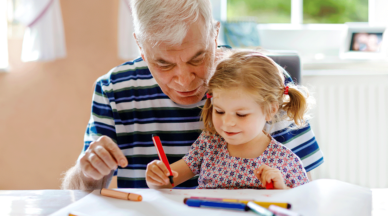 grandpa coloring with granddaughter at home