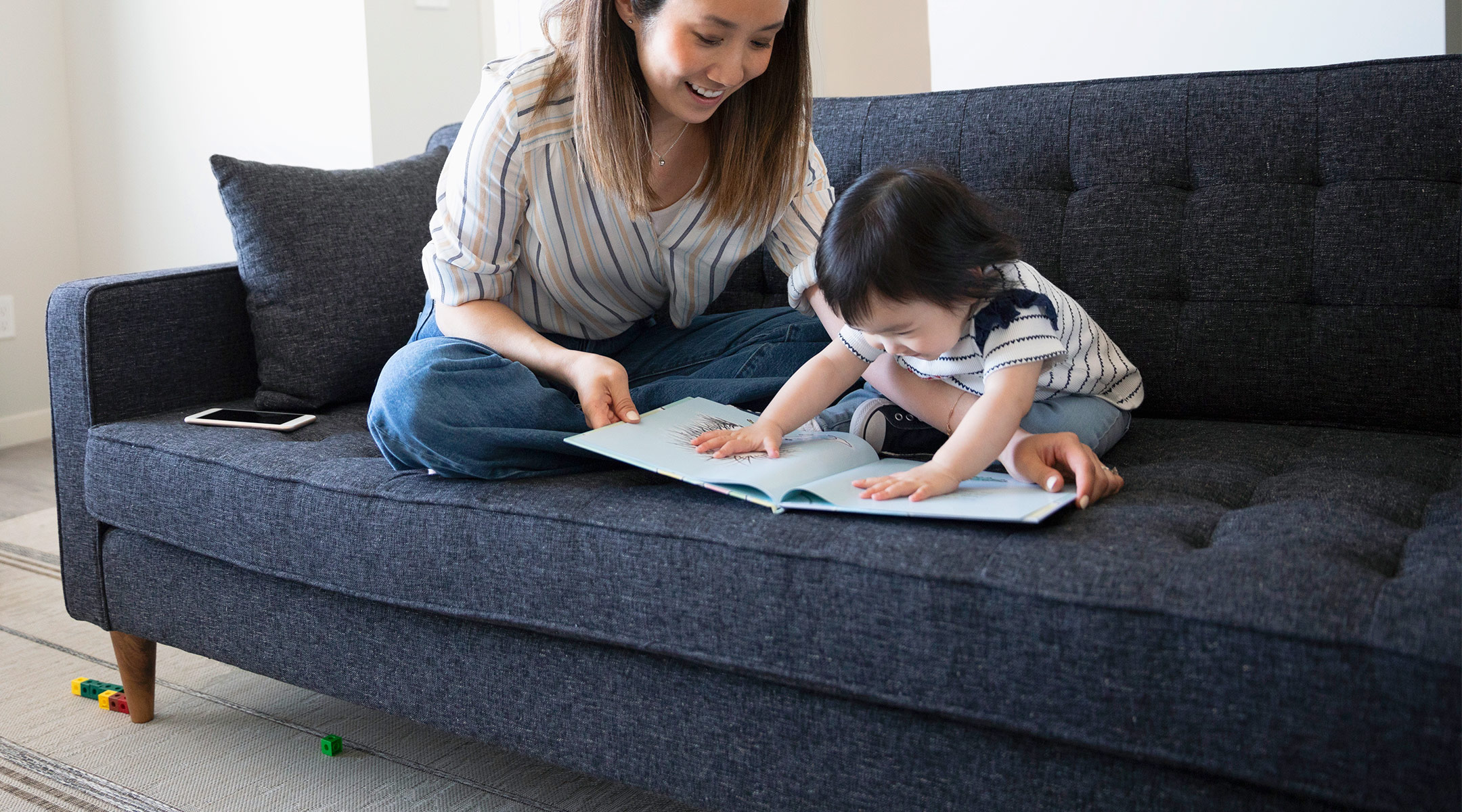 mom reading with her toddler indoors