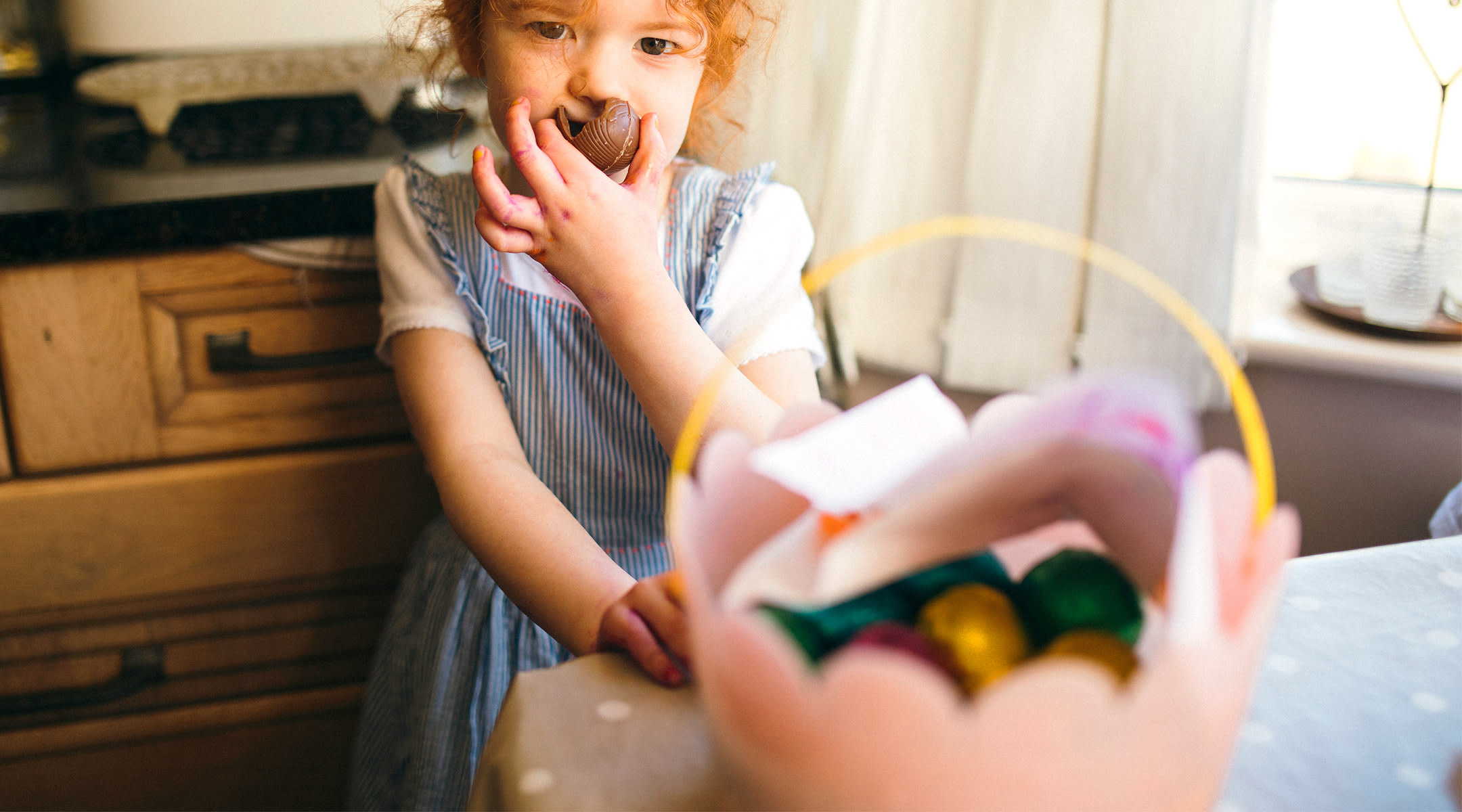 little girl eating her easter basket chocolate