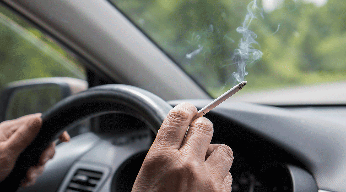 driver smoking a cigarette inside a car