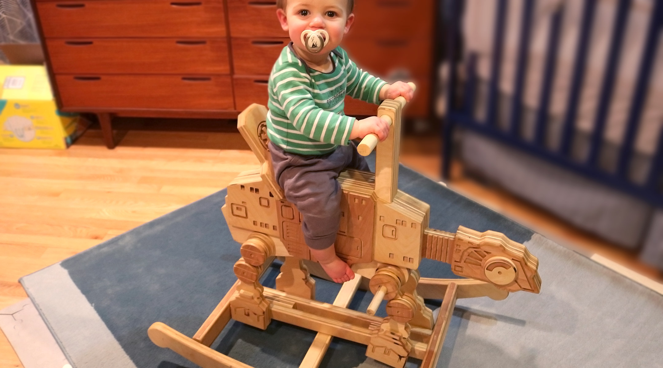 toddler riding custom star wars rocking horse made by his dad