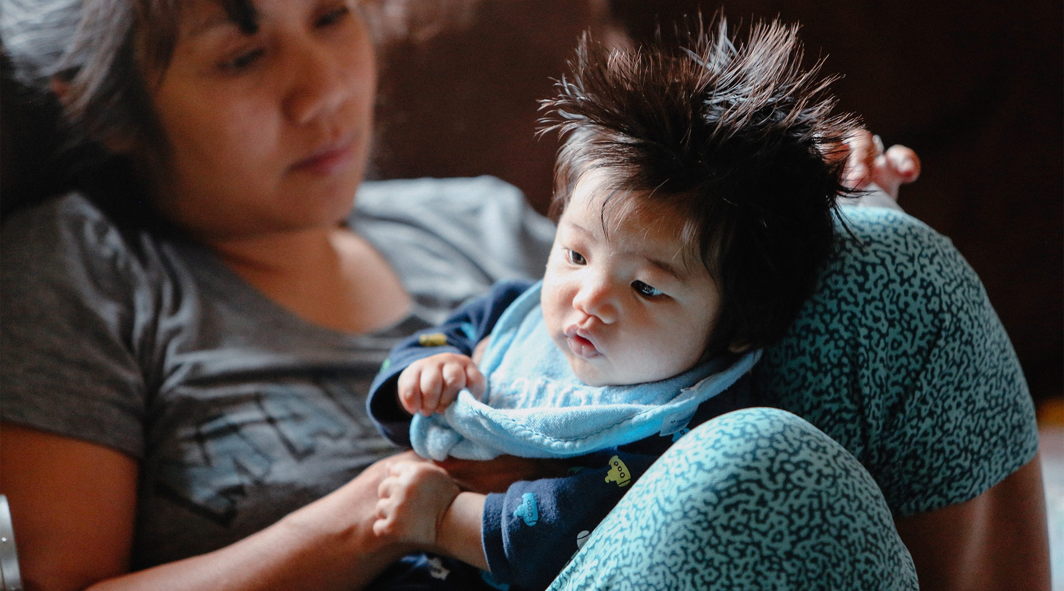 unhappy mom holding her baby