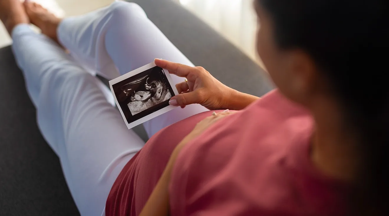 pregnant woman looking at ultrasound picture