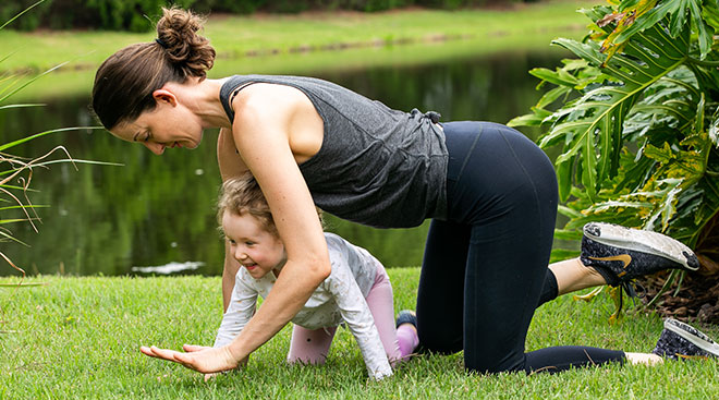 Exercise contributor exercising outside with her toddler daughter.