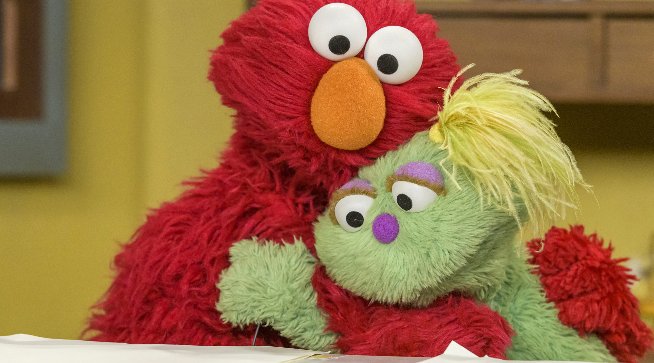 sesame street characters hugging, sesame street launches initiatives to support foster children