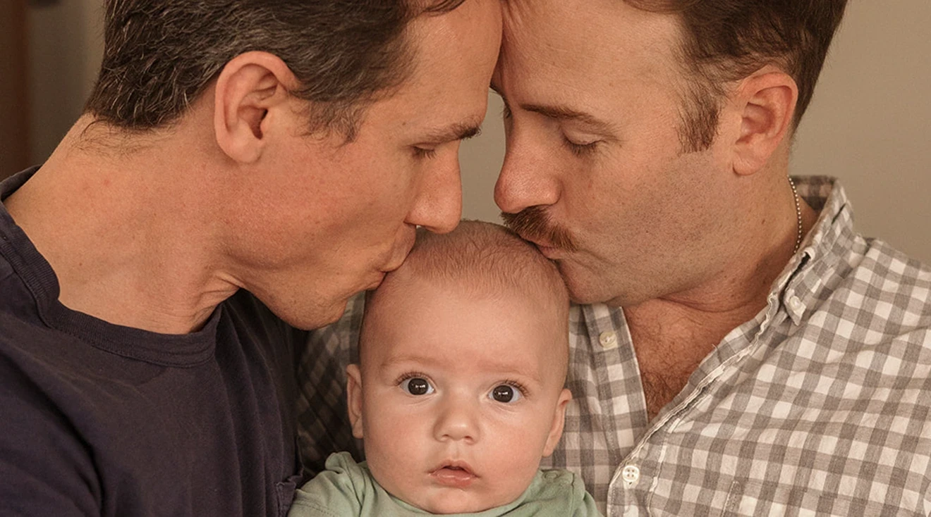broadway husbands Bret Shuford and Stephen Hanna kissing their baby son