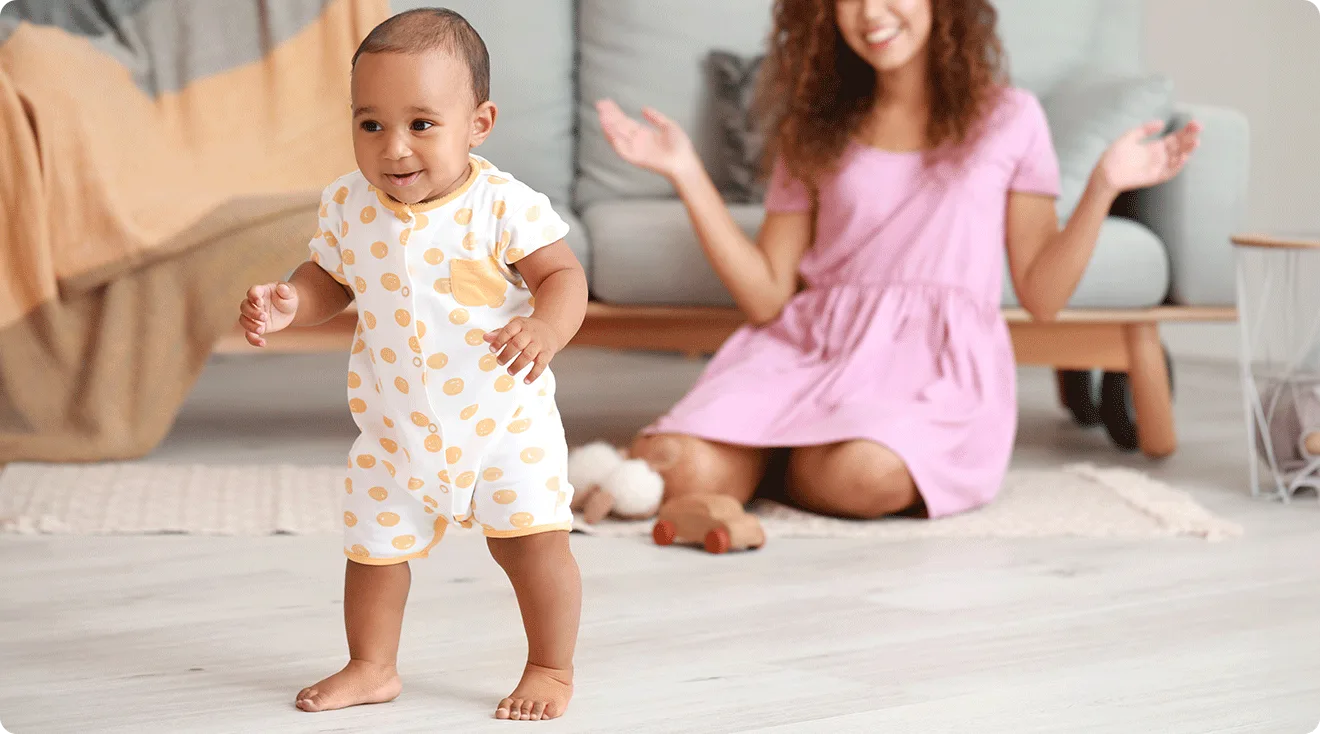baby taking first steps at home