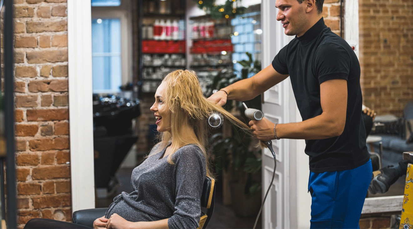 pregnant woman getting hair done at hair salon