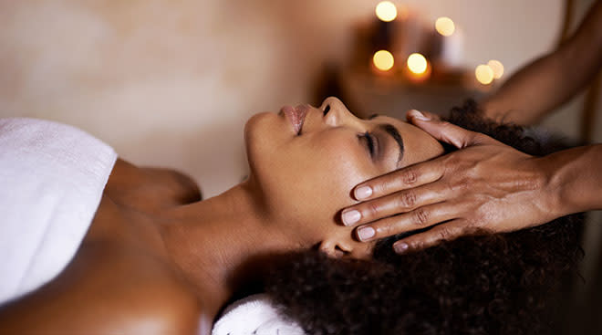 Woman relaxing while getting a massage at a spa. 