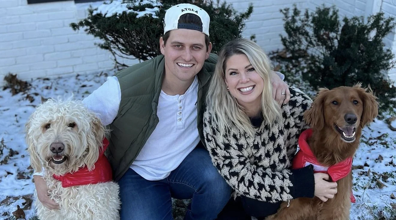 austin burke and wife lexy smiling outside with dogs