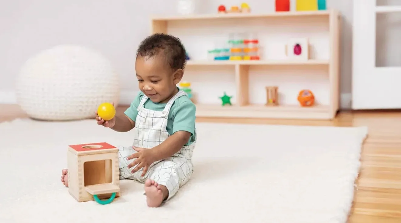 baby playing with toy box
