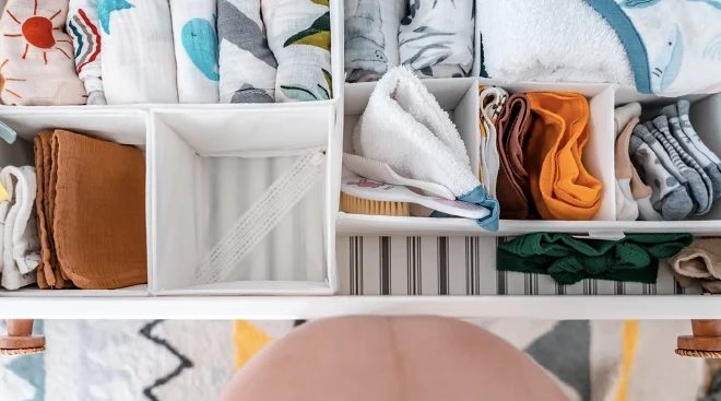 pregnant belly against open drawer filled with baby essentials