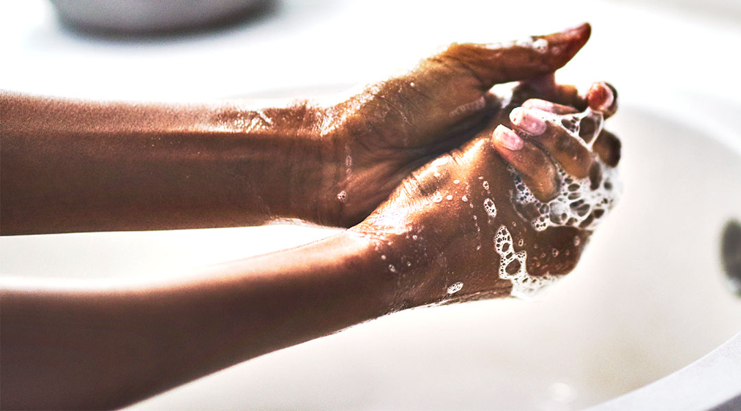 person sudsing their hands before washing