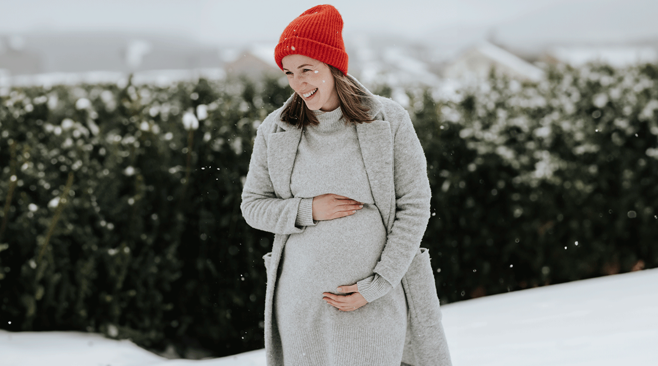 pregnant woman outside in the snow during winter