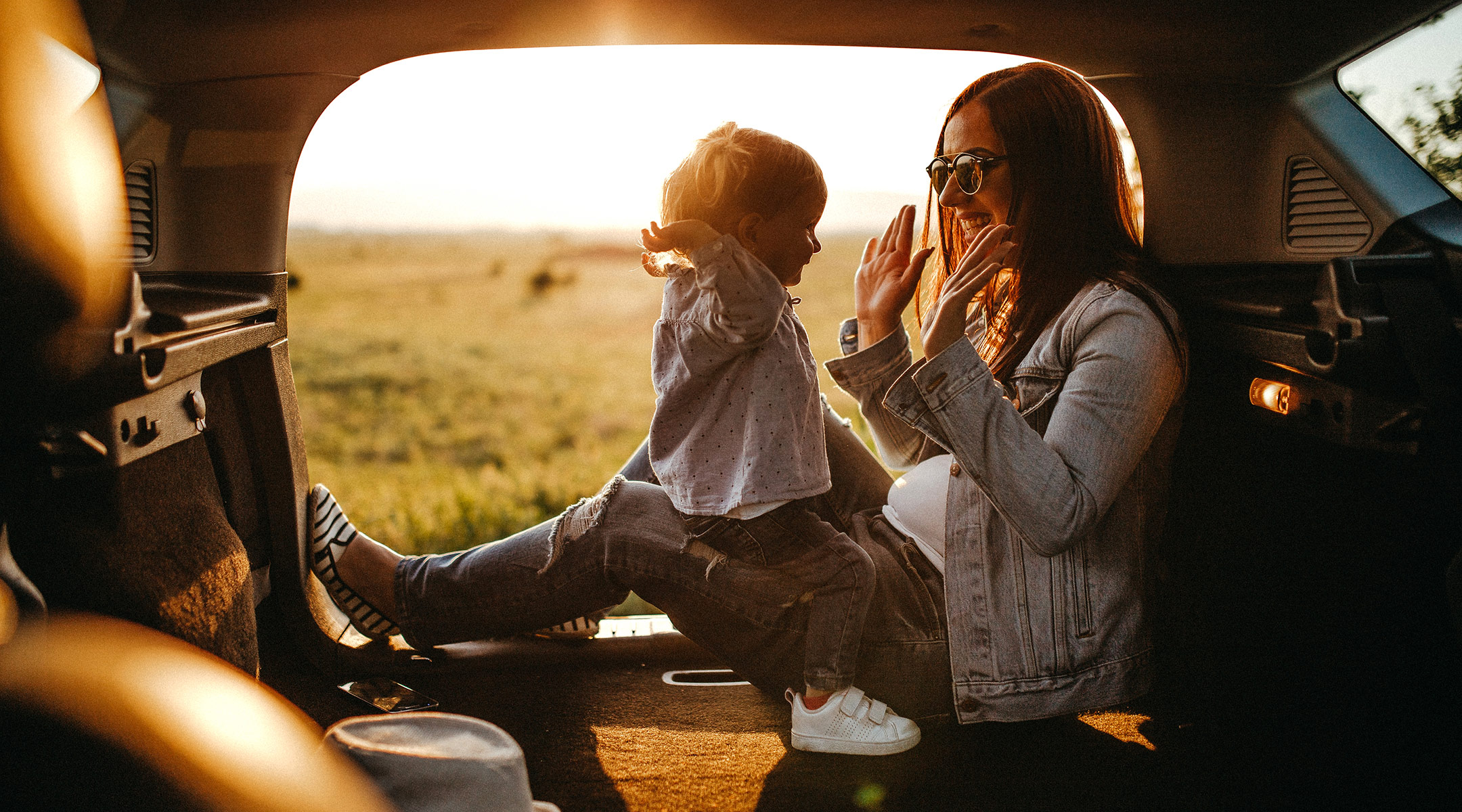 mom in back of car with baby