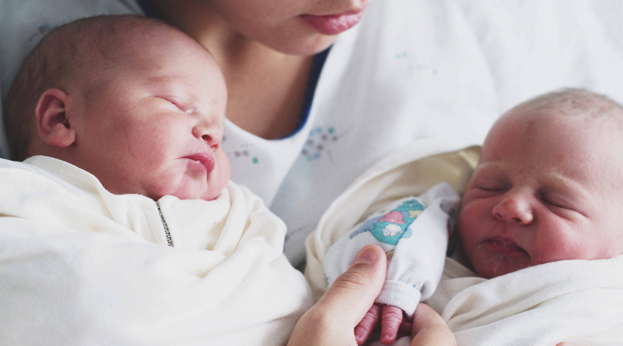 new mom holds newborn twins