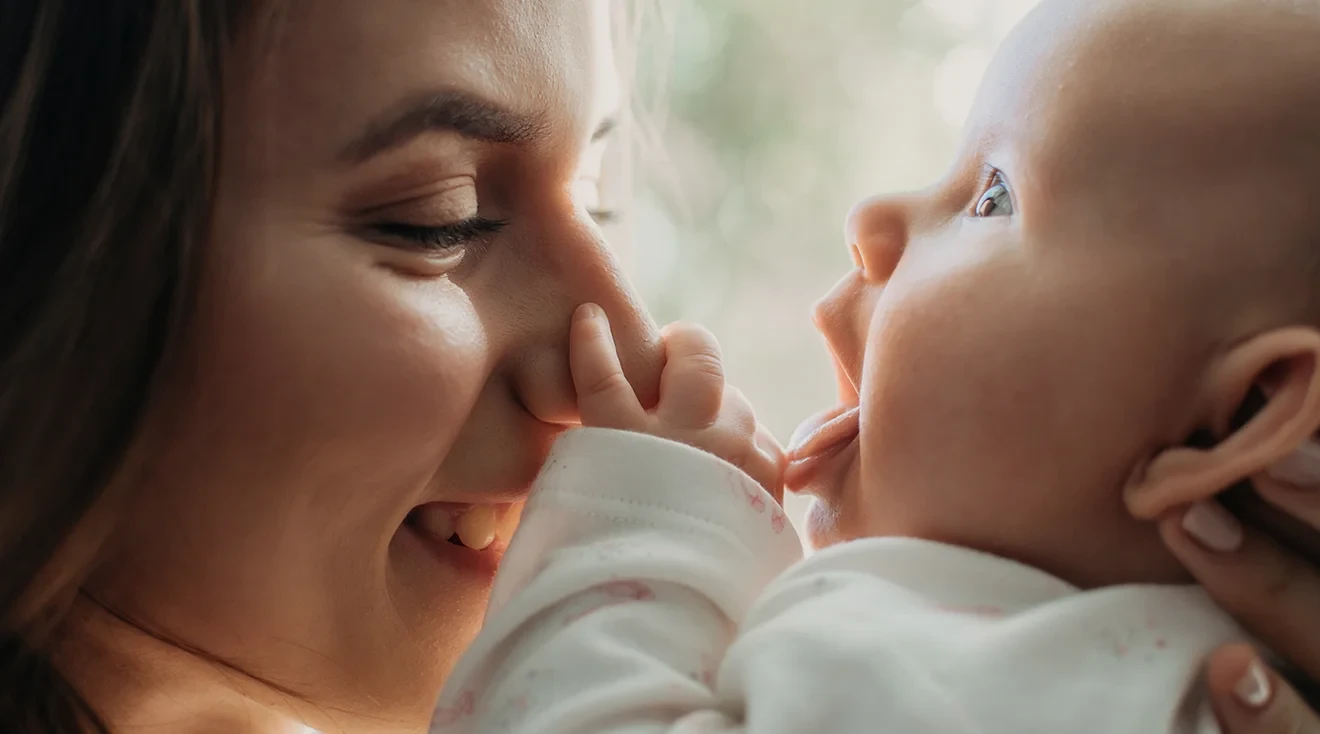 mother and baby smiling and cuddling