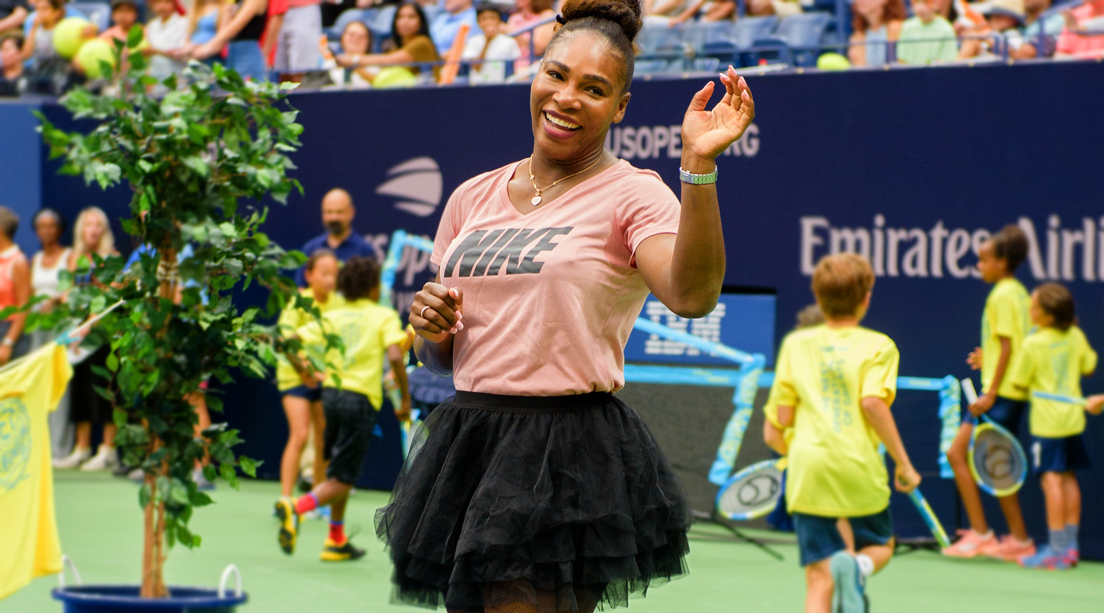 serena williams at tennis match laughing and wearing tutu