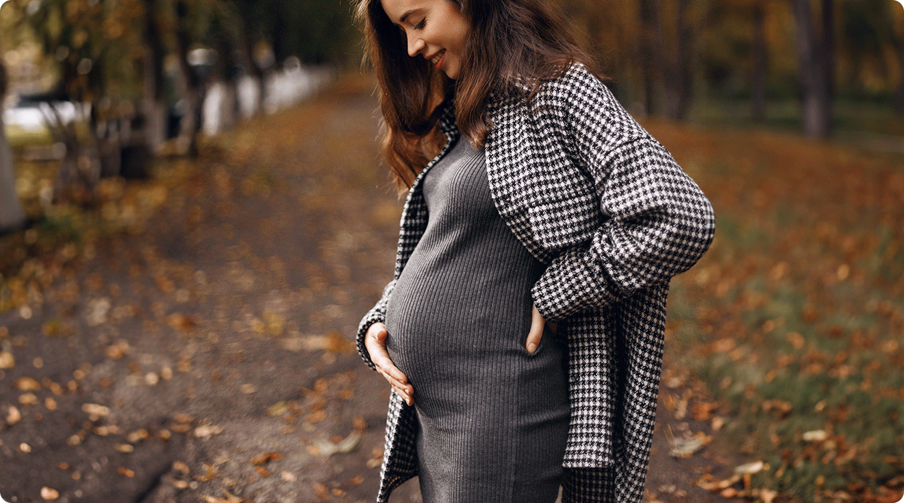 pregnant woman wearing a dress in autumn weather