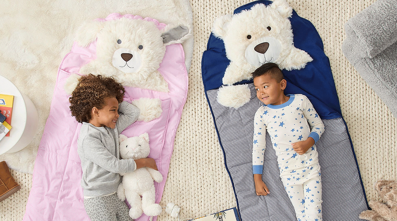 two toddlers lying on nap mats